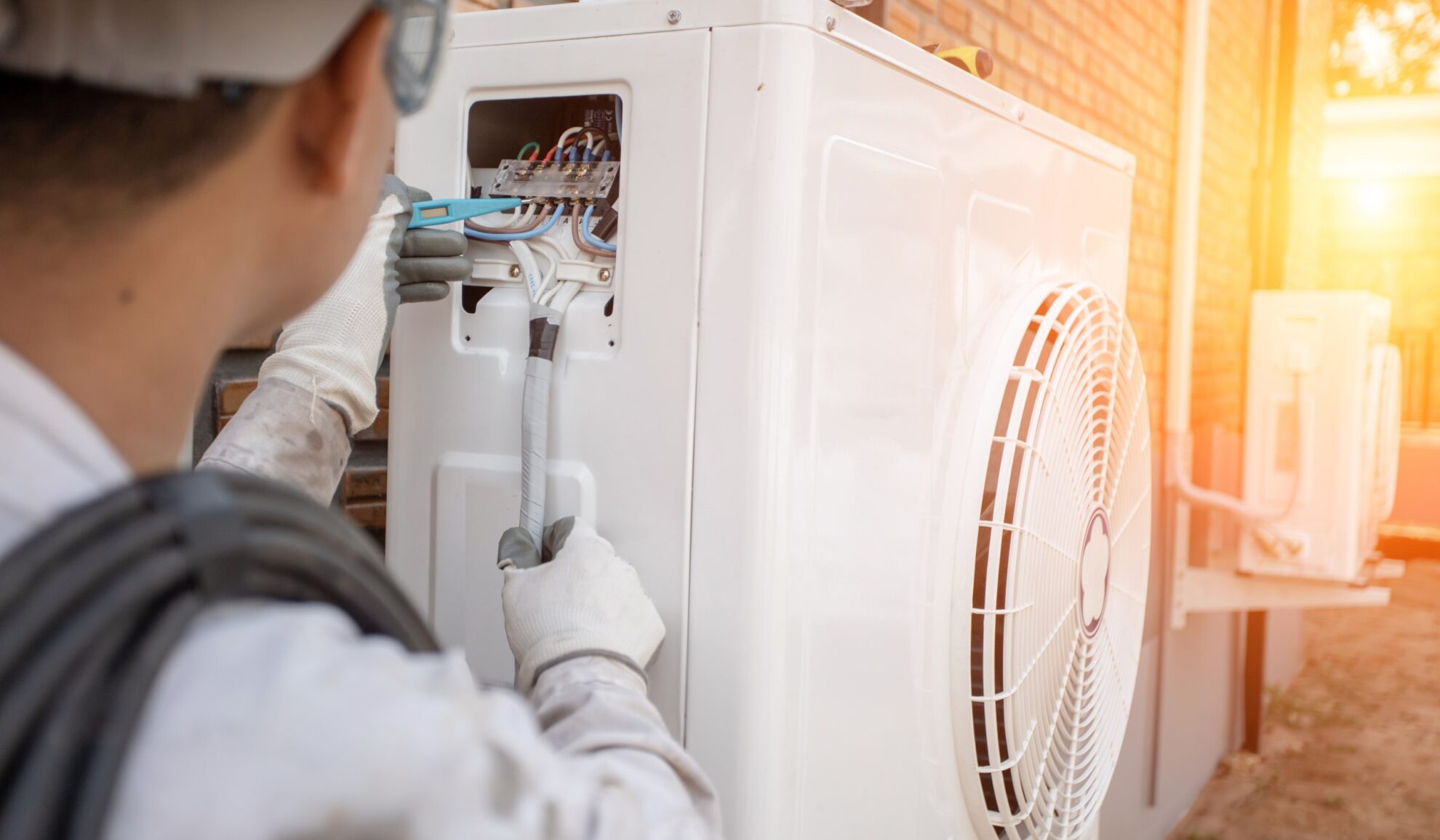 man fixing heat pump Crossfield TN