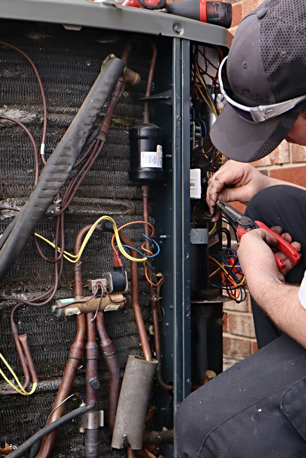 man fixing hvac outside a building Crossfield TN